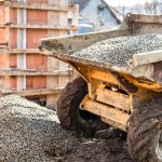 Dumper truck unloading construction gravel, sand and curshed stones